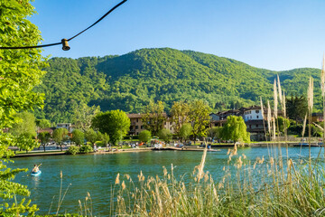 Spring view of Lake Lugano in the town of Caslano in the Swiss mountains