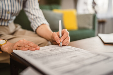 Close up of hand unknown woman sign document work from home