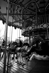 Black and white photo of a vintage carousel in motion, evoking childhood memories and nostalgia....