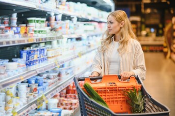 Portrait Of Smiling Woman With Shopping Cart In Supermarket Buying Groceries Food