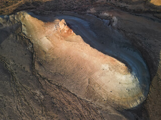 Cinematic movement along the crest shows Aktumsik Cape's dramatic colored mounds. Layered strata...
