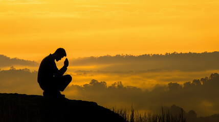 A man’s silhouette kneels in prayer atop a mountain at sunrise. Golden light fills the sky, mist veils the valley below. The scene evokes deep solitude, surrender, and spiritual reflection.