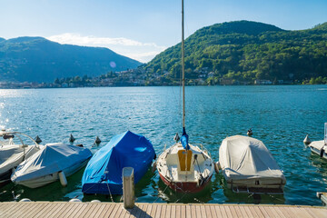 View of boats moored on Lake Lugano, village of Caslano. Switzerland