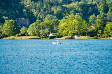 Fototapeta premium Spring view of Lake Lugano in the town of Caslano in the Swiss mountains