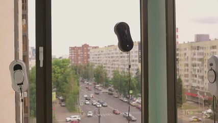 A man uses an automatic window cleaner for sparkling, crystal-clear glass and a spotless finish
