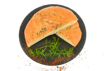 Freshly baked flat small bread with cheese, garlic and spices on black tray isolated on white.