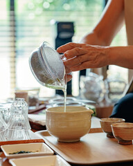 Hot green tea poured into mixing bowl