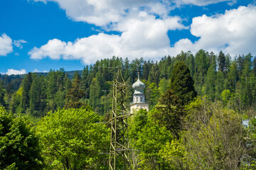 Old traditional Swiss open-air chapel in spring. View of the Alps. Caslano.