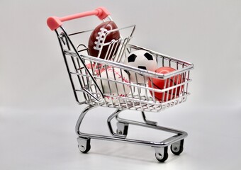 miniature cart full of balls from various sports