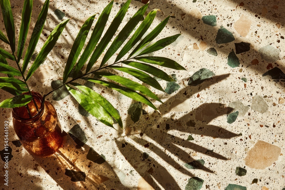 Poster sunlight and shadows dance around a leaf in a vase on a terrazzo surface, capturing the essence of a