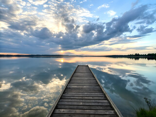 Fototapeta premium A Wooden Board walk into a lake with a beautiful sunset