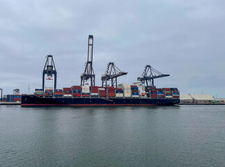 Ensenada, Mexico, June 5, 2025: The Entrance to Ensenada Harbor looking at Container Cranes loading ships for sea cargo from the quayside