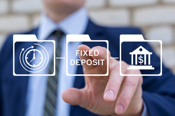 Business person using virtual touch screen presses the inscription: FIXED DEPOSIT. Fixed deposit as business and financial concept.