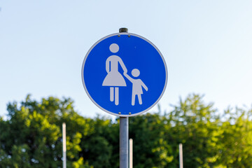 Blue Pedestrian Crossing Sign with Adult and Child Figures