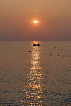 the atmosphere of the fishermen in the evening after returning home from fishing in the sea using a wooden boat