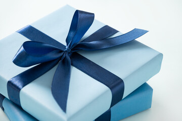 Two blue gift boxes for birthday on pastel blue background. Greeting card, flyer or invitation....