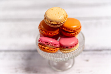 macaroni cookies, sweet and colorful french macaroni, french dessert, mix of appetizing macaroni on white wooden table