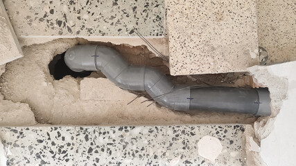 Sewage pipe installation and repair process in a residential building under renovation
