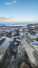 Exploring the rocky shoreline of Spain with tidal pools and ocean views during sunset hours