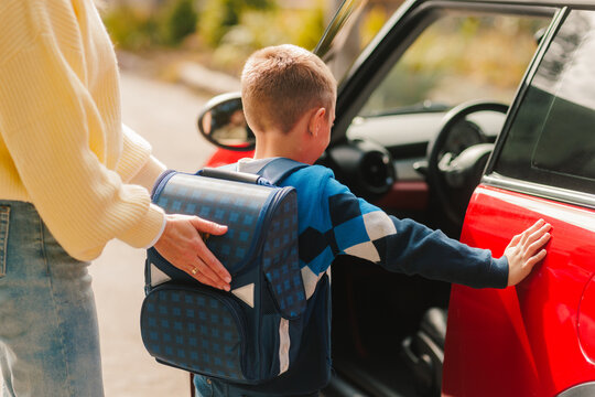 Back to School Morning Drop Off – Child with Backpack and Parent Getting into Car for School Day