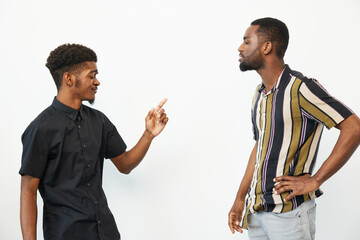 Two African American men engaging in a lively conversation, showcasing expressions of joy and...
