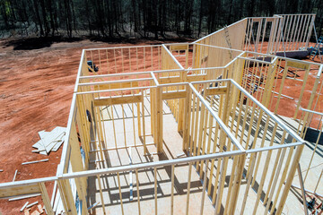 Contractor are assembling wooden beams frames for new house on construction site in suburban...
