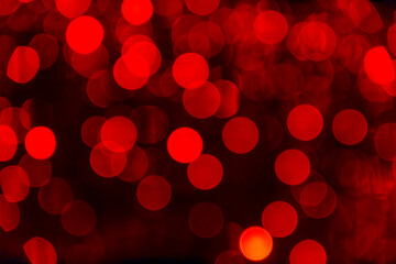 Red bokeh background with soft glowing lights for creative designs and art projects