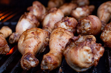 Smoky Chicken Legs Cooking on Outdoor Grill in Summer. Flat-Lay of Seasoned Chicken Drumsticks on BBQ Grill