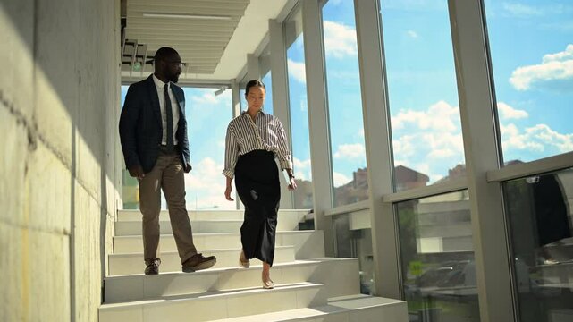 Business people walking and talking on stairs