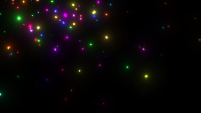 Multicolored glowing particles floating and twinkling on a dark background. Abstract looped animation perfect for celebration themes, party visuals, festive backgrounds, or digital effects in motion