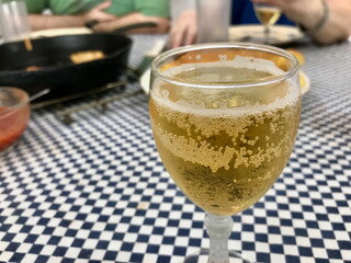Glass of Apple Cider with Spanish Tapas in Background