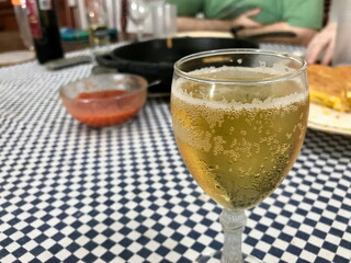 Glass of Apple Cider with Spanish Tapas in Background