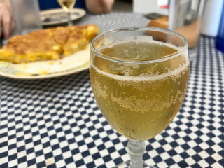 Glass of Apple Cider with Spanish Tapas in Background