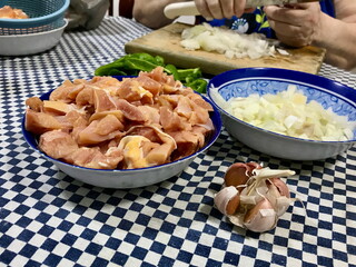 Raw Chicken Pieces in Blue Plastic Bowl