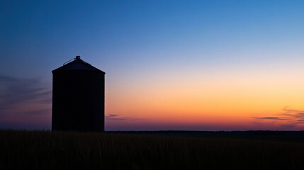 Rural twilight silhouette, Grain bin against gradient sunset vista