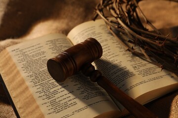 Judge's gavel, Bible and crown of thorns on burlap fabric, closeup
