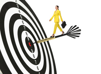Goal achievement, business success and targeting. Businesswoman walking on dart sticking in center...