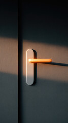 Door handle illuminated by warm light with shadow
