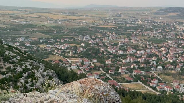 View from the mountain to the town of Korkuteli, Antalya. Panoramic view of the city. Houses with rooftops. Daytime