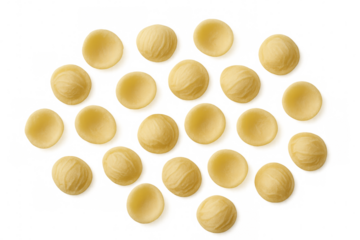 Small ear-shaped orecchiette pasta creating a visually appealing pattern against a transparent background, highlighting its unique texture