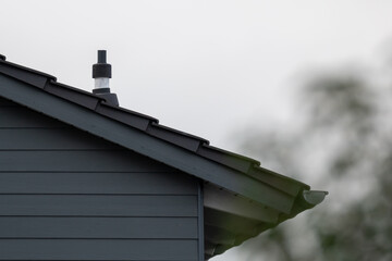 A house with a blue roof and a chimney