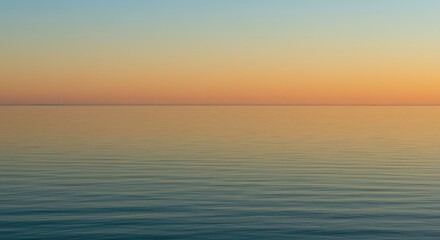 Obraz premium A serene sunset over a calm body of water. Soft colors blend seamlessly
