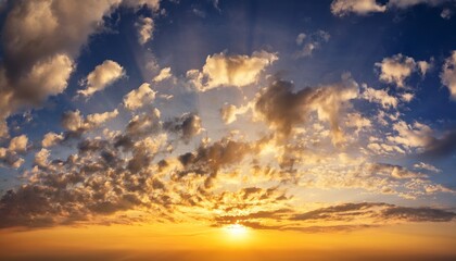 Fototapeta premium golden sky at sunrise with dramatic clouds warm sunlight and peaceful atmosphere perfect for nature backgrounds or tranquil landscape scenes