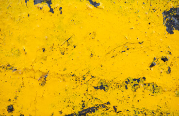 A yellow and black background with a lot of paint splatters