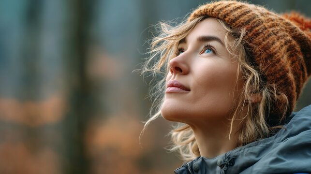 Inspiring woman gazing upward in autumn forest lifestyle portrait nature calm atmosphere close-up perspective