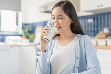 Close-up woman a glass of drink milk in the morning