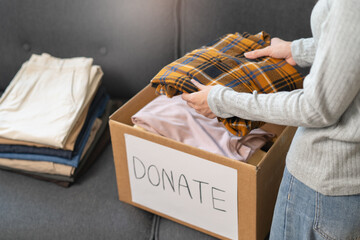 Organize closet and storage concept, people prepare unwanted old fashion clothes for share donation.