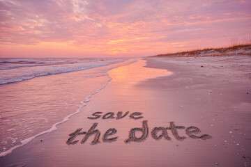 Save the date handwritten in natural sand on a pastel beach during golden hour, with soft lavender and pink hues, clean copy space to the right, perfect for wedding invitations, branding, or design