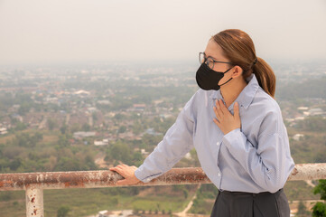 Businesswoman having respiratory allergy caused of by Bad air pollution (PM2.5). PM2.5 levels...