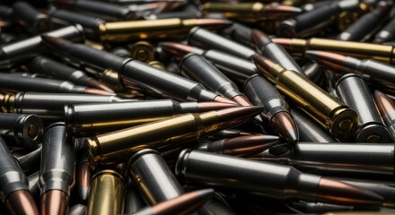 Naklejka na ściany i meble Close up of a large jumbled pile of silver and gold rifle ammunition cartridges